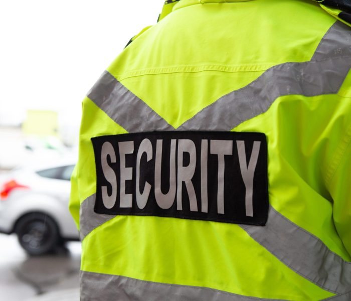 A,Closeup,Shot,Of,A,Back,Of,Security,Guard,Watching